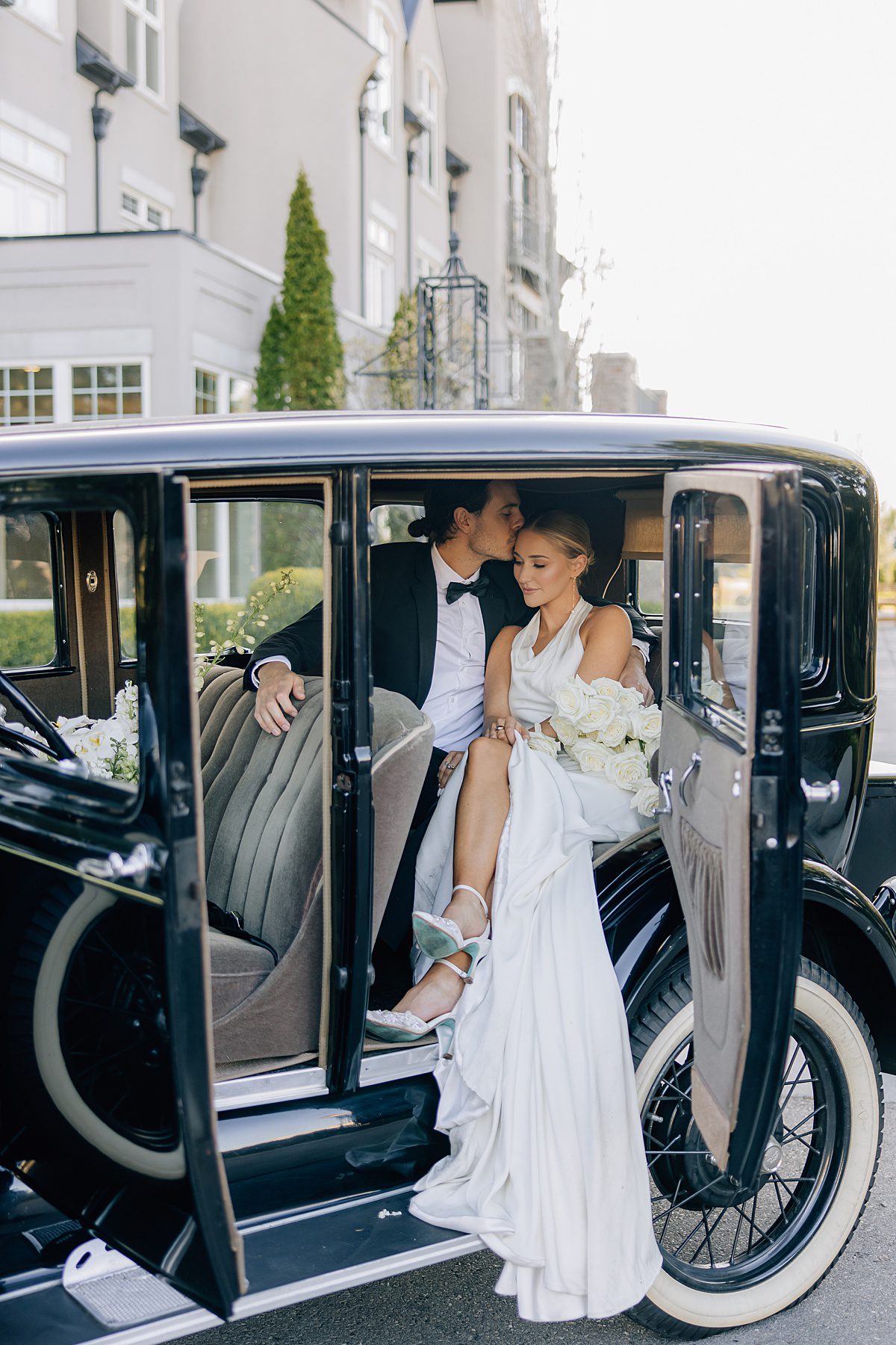 bride and groom in vintage car