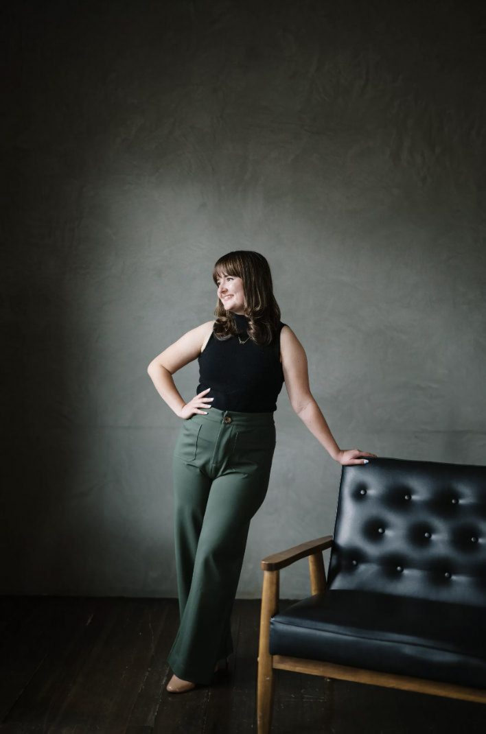 photo of amy standing next to a couch