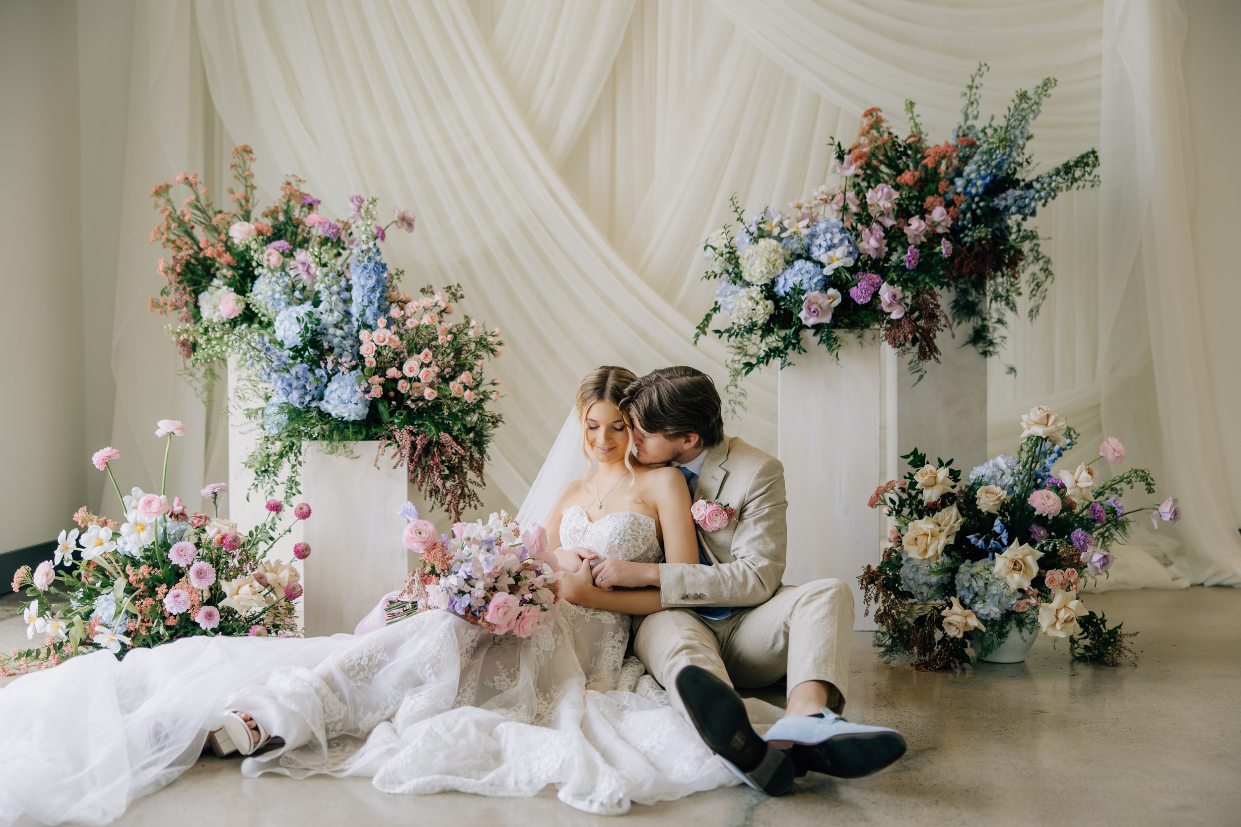 The belvedere, bride and groom sitting surrounded by flowers